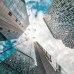 Low angle view of modern skyscrapers reflecting the cloudy sky in Brussels, Belgium.