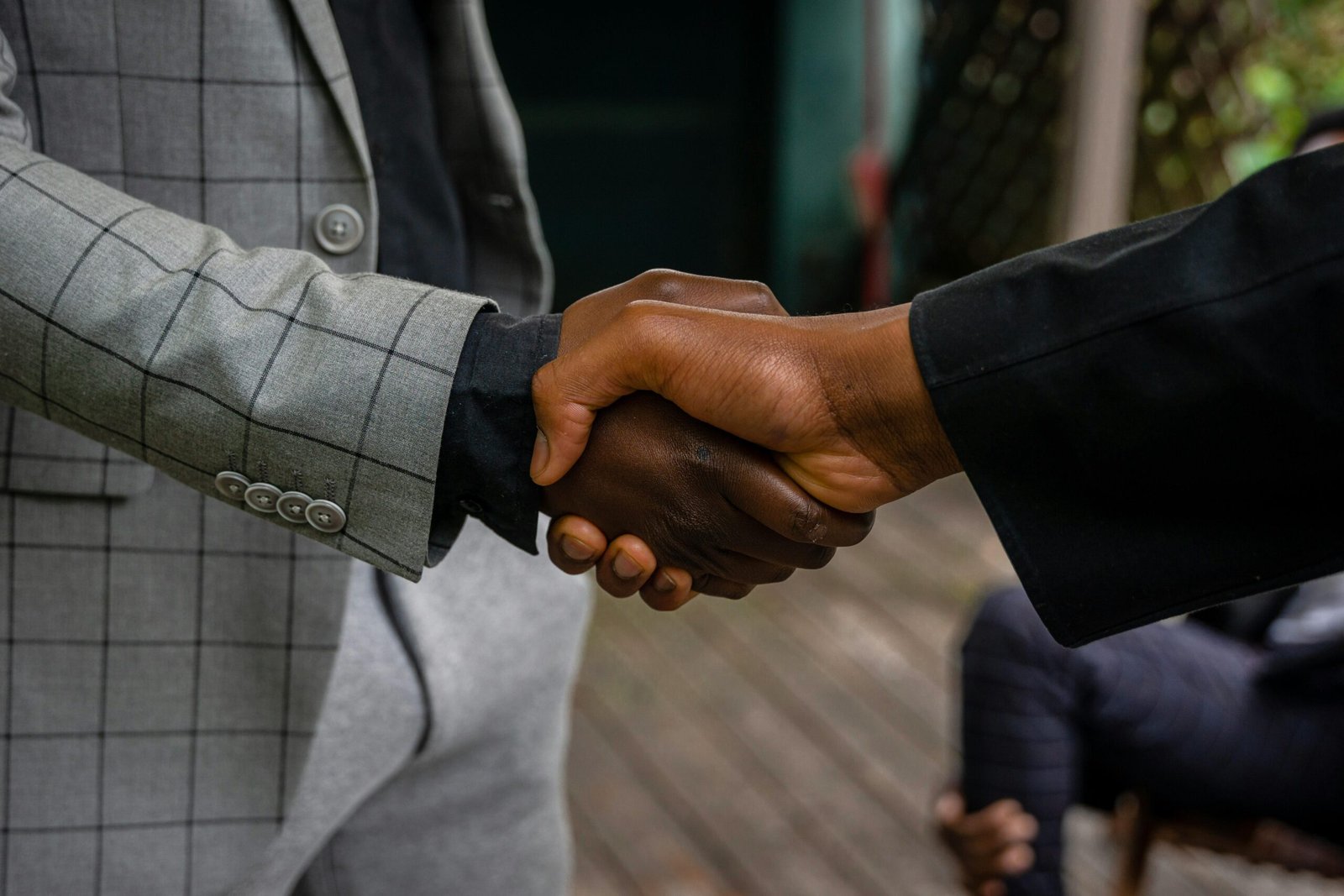 Home Close-up of two professionals shaking hands, symbolizing success and partnership.